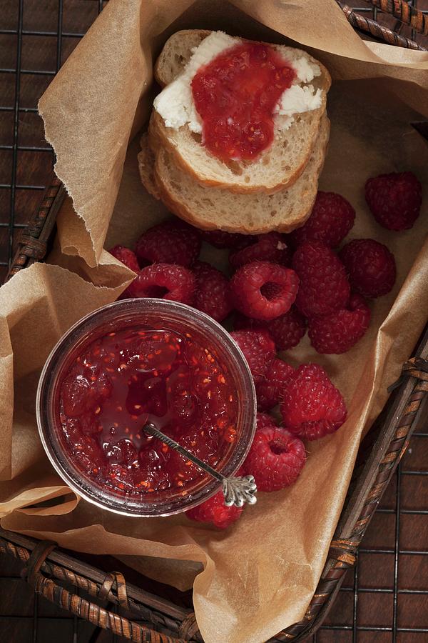 Homemade Raspberry And Mango Jam In A Basket With Slices Of Bread And Fresh Raspberries Photograph by Katharine Pollak