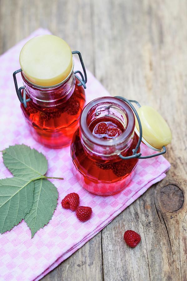 Homemade Raspberry Vinegar In Flip-top Bottles Photograph by Brigitte Sporrer
