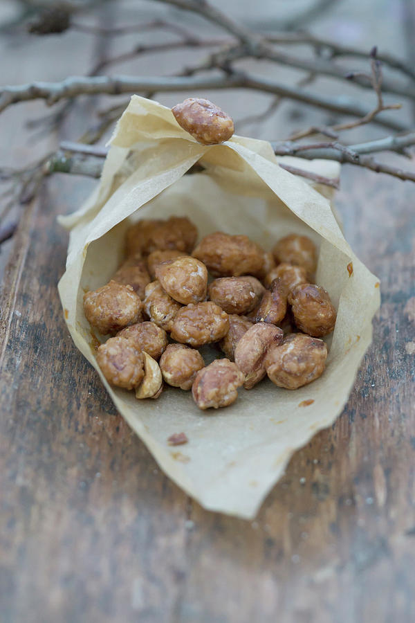 Homemade Roasted Almonds In A Paper Bag Photograph by Martina Schindler