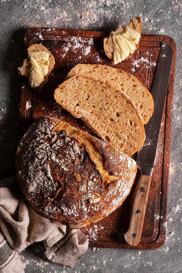 Homemade Sourdough Bread On A Wooden Board With A Knife Photograph by Karolina Polkowska
