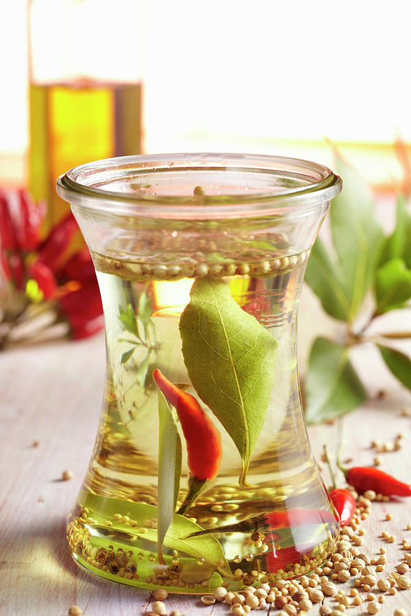 Homemade Spice Oil With Chili, Bay Leaves, Mustard, Coriander And Cardamom Photograph by Teubner Foodfoto