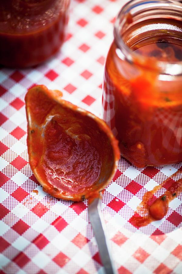 Homemade Tomato Sauce In A Ladle And A Jar Photograph by Eising Studio