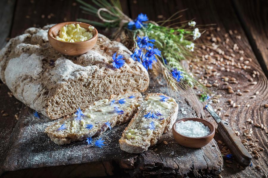 Homemade Wholemeal Bread With Butter And Salt On An Old Wooden Board Photograph by Shaiith