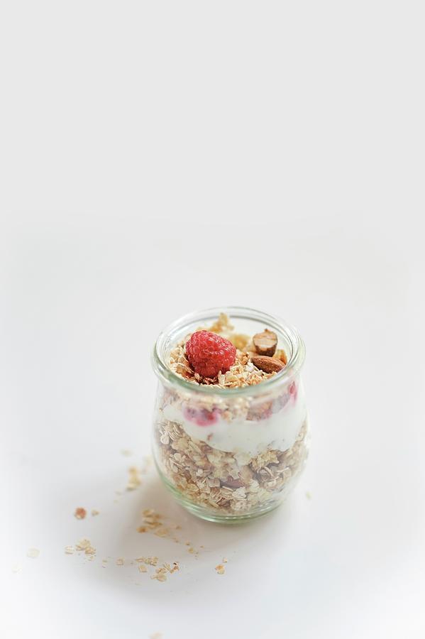 Honey And Almond Muesli With Raspberries In A Glass Photograph by Alexandra Feitsch