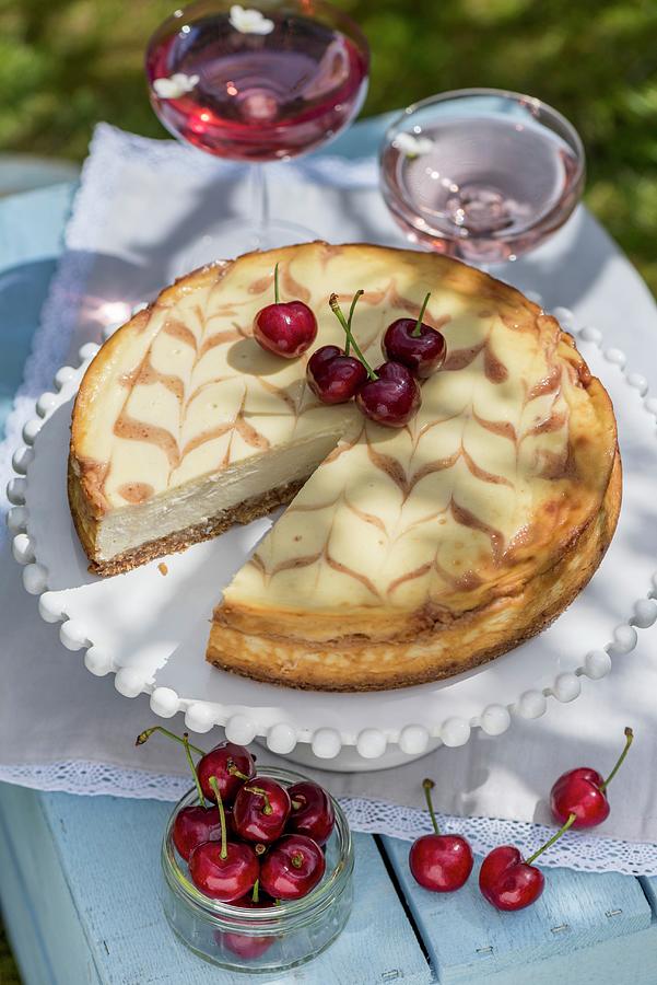 Honey Cheesecake With Cherries On A Table Outdoors Photograph by Winfried Heinze
