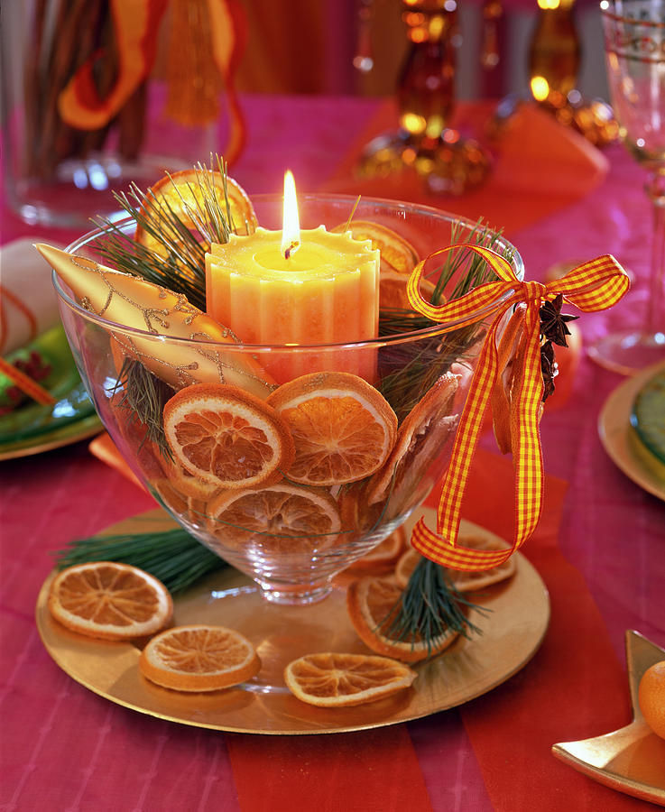 Honey-colored Candle In Glass Cup Filled With Orange Slices Photograph by Friedrich Strauss