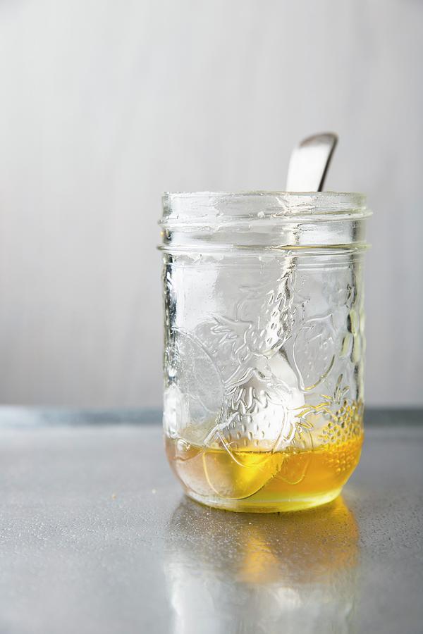 Honey In Preserving Jar With A Spoon On A Metal Tray Photograph by Keller & Keller Photography