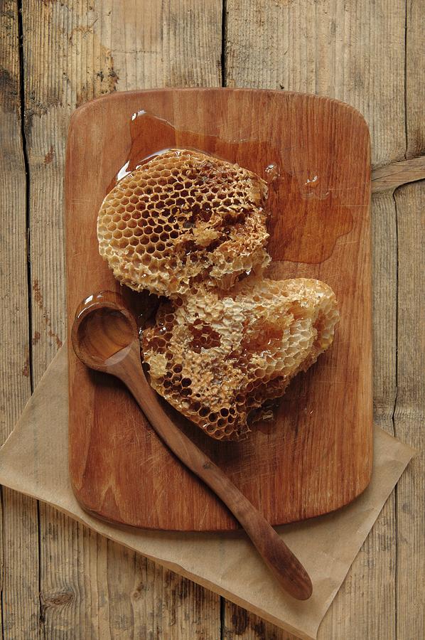 Honeycomb From Wild Bees On A Wooden Board With A Wooden Spoon Photograph by Edyta Girgiel