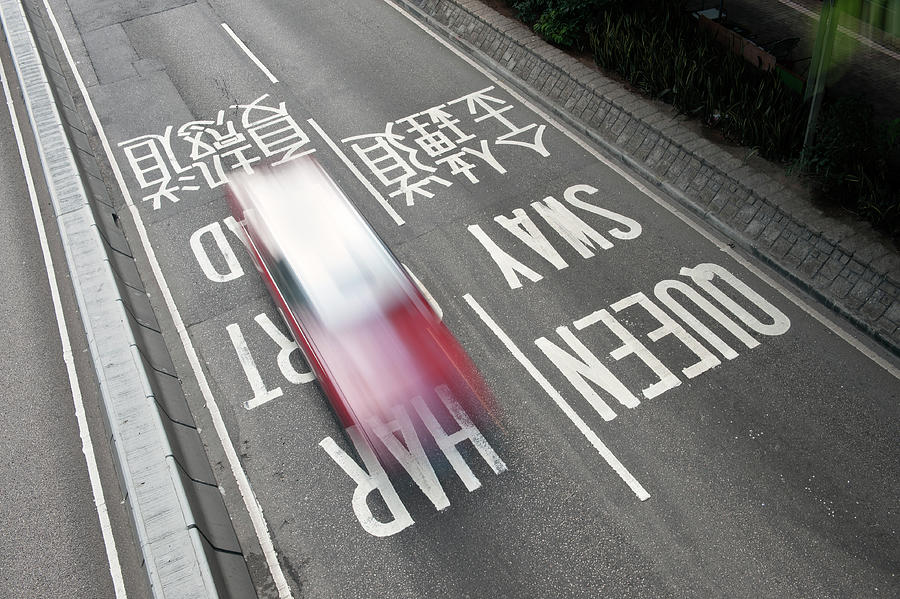 Hong Kong Taxi Drives Over Road Signs, China Photograph by Gnther Bayerl