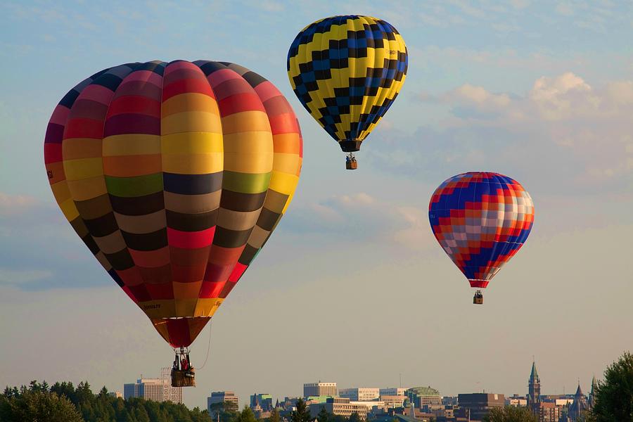 Hot air balloons flying over the city Photograph by Tatiana Travelways
