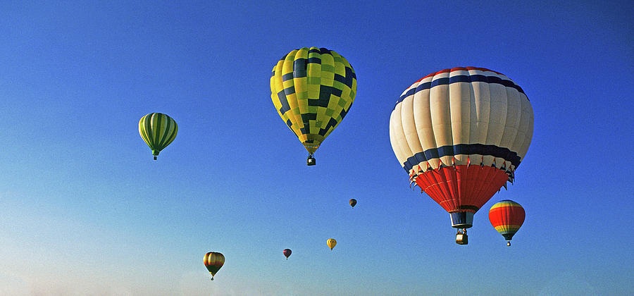 Hot Air Balloons Rise Over The Desert Photograph by Buddy Mays