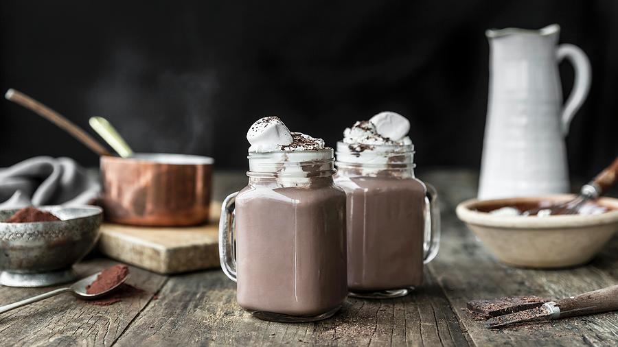 Hot Chocolate With Whipped Cream In Glass Mugs Photograph by Sarah Coghill