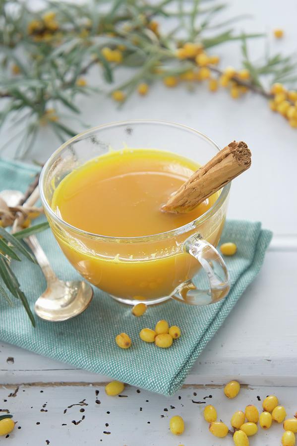 Hot Orange Juice With Seaberries And A Cinnamon Stick Photograph by Martina Schindler