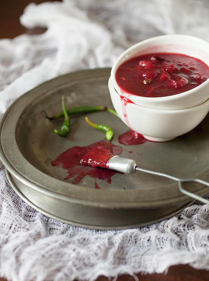 Hot Plum Sauce With Chilli In A Bowl On A Metal Plate Photograph by Katharine Pollak