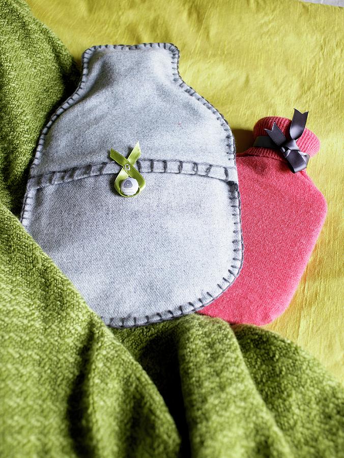 Hot Water Bottles With Handmade Covers Made From Vintage Fabric On A Green Wool Blanket Photograph by Jo Tyler