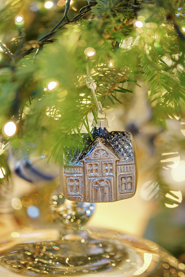 House-shaped Christmas Bauble Hanging From Branch Photograph by Angelica Linnhoff