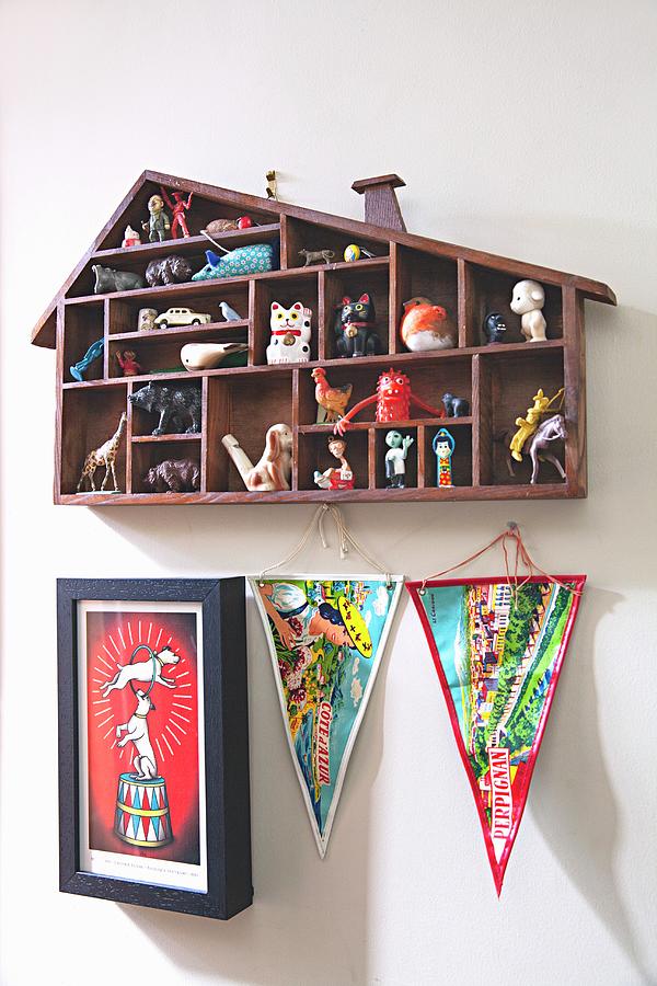 House-shaped Display Case Above Pennants And Picture On Wall Photograph by Natalie Jeffcott