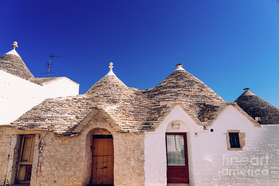 Houses of the tourist and famous Italian city of Alberobello, with its typical white walls and trulli conical roofs. Photograph by Joaquin Corbalan
