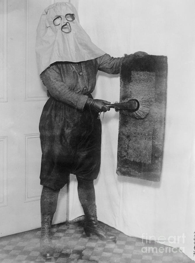 Housewife Wearing Hood While Dusting Photograph by Bettmann