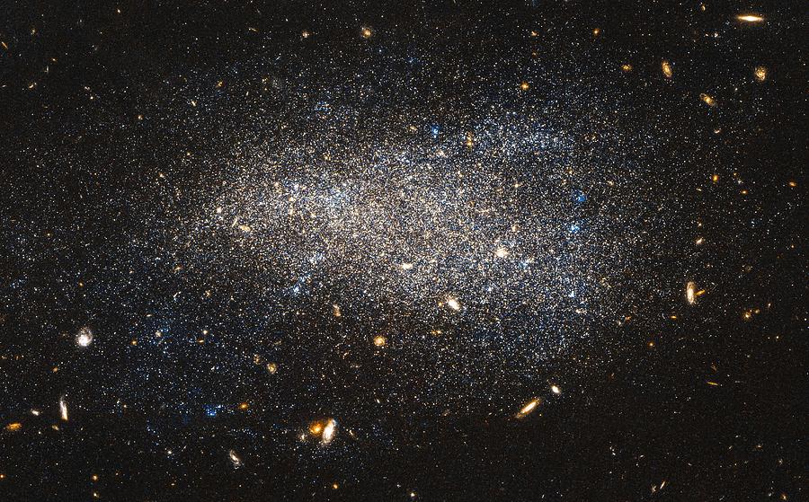 Hubble Nets a Subtle Swarm . This Hubble image shows NGC 4789A, a dwarf irregular galaxy in the cons Painting by Celestial Images