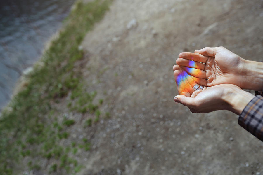 Abstract Photograph - Human Hands Catching The Rainbow Light Made By Prism by Cavan Images