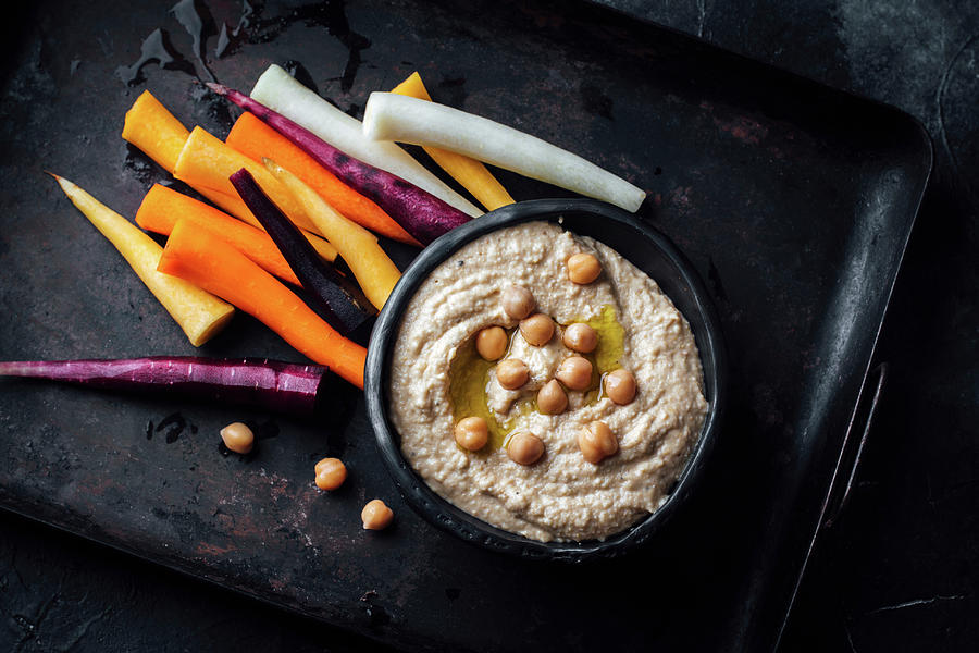 Hummus And Colourful Carrot Sticks Photograph by Kate Prihodko