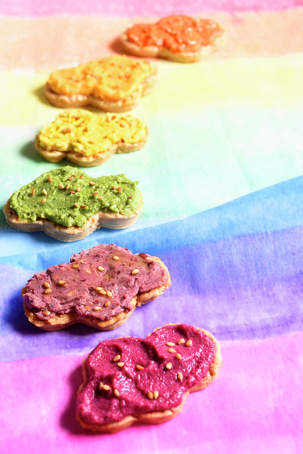 Hummus Beetroot, Red Bean, Orange Lentil And Spirulina, Curry, Carrot And Pepper On Cloud-shaped Sesame Biscuits Photograph by Jonneskindt