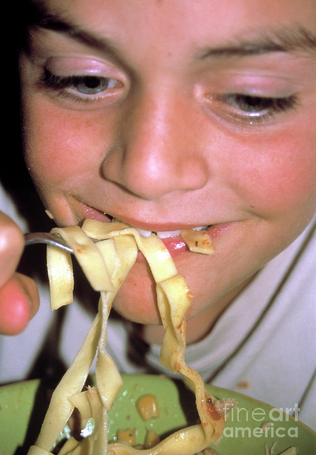 Hungry Boy Eating Pasta by Mark Clarke/science Photo Library