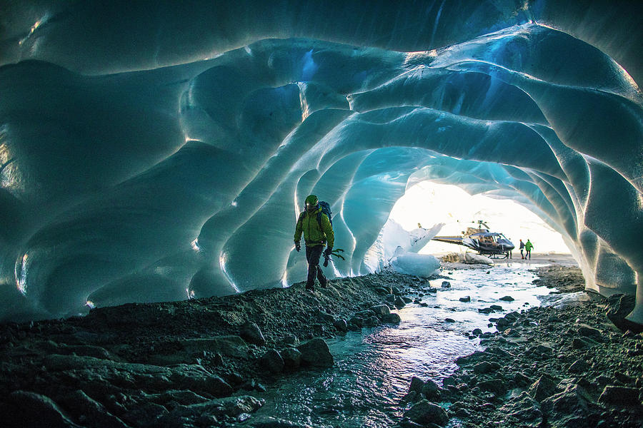 Ice Climber Enters Ice Cave To Find A Climbing Route. Photograph by ...