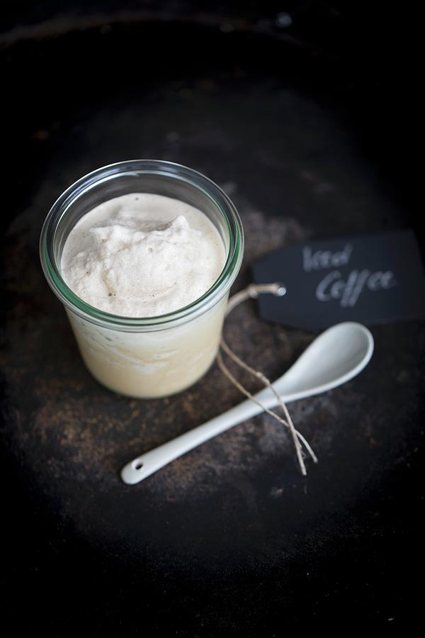 Ice Coffee In A Jar With A Porcelain Spoon On A Dark Surface Photograph by Tina Engel