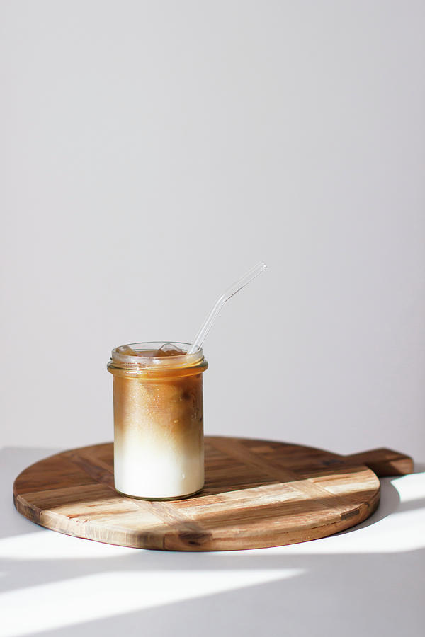 Ice Coffee On A Wooden Board Against A White Background Photograph by Annalena Bokmeier