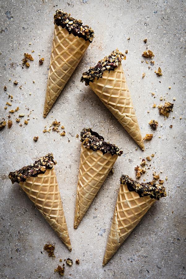 Ice Cream Cones Dipped In Chocolate And Brittle Photograph by Magdalena Hendey