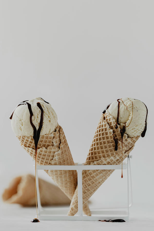 Ice Cream Cones With Vanilla Ice Cream And Dripping Chocolate Sauce Photograph by Valeria Aksakova