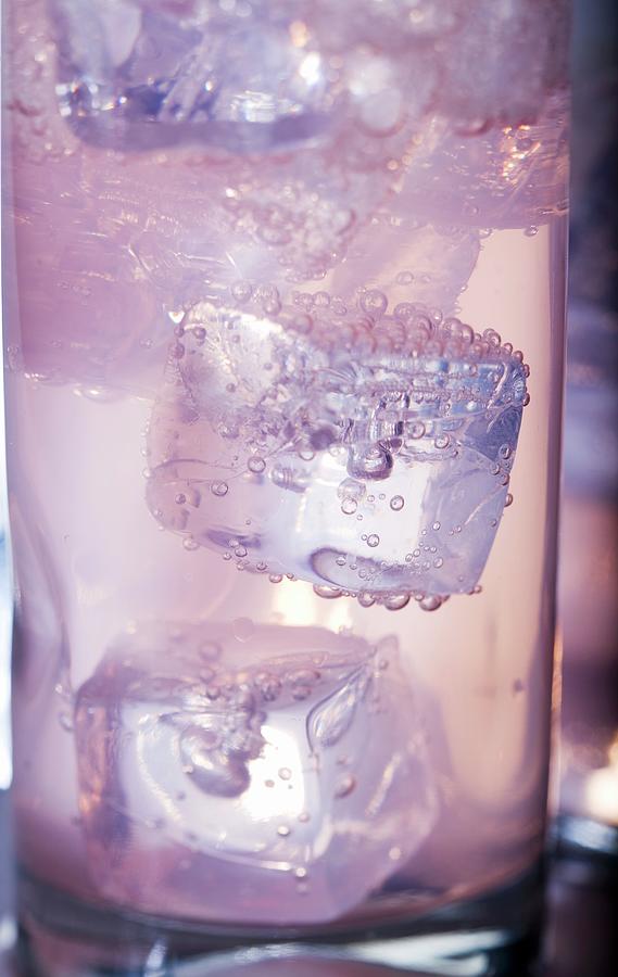 Ice Cubes In A Glass Of Blackberry Seltzer Photograph by Zaki, Mira