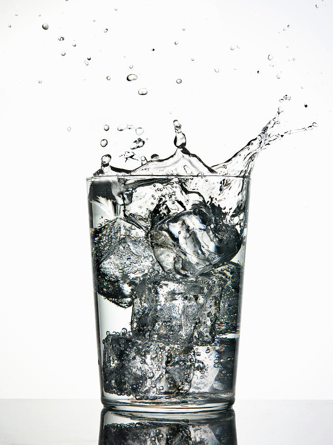 Ice Cubes Splashing Into Fizzy Drink Photograph by Walter Zerla