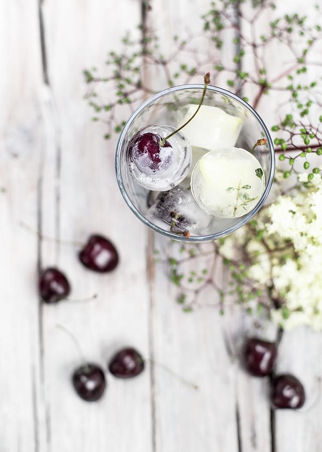 Ice Cubes With Cherries In A Jar Photograph by Carolina Auer Photography