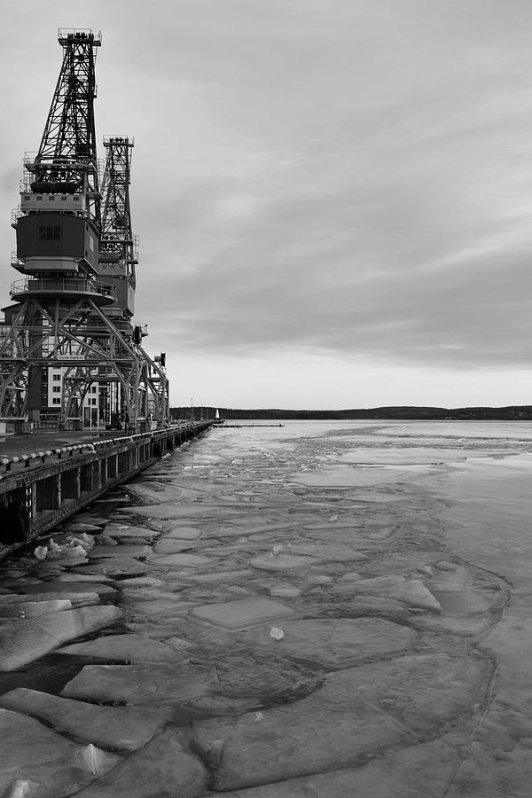 Ice floes are floating on a harbor bay in winter - monochrome Photograph by Intensivelight