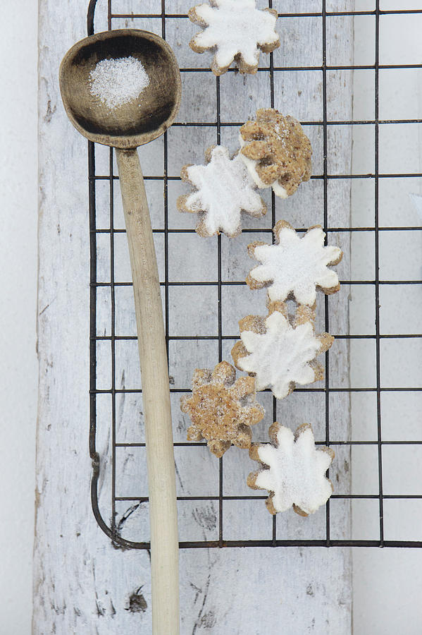 Iced Flower-shaped Cinnamon Biscuits On A Wire Rack Photograph by Martina Schindler