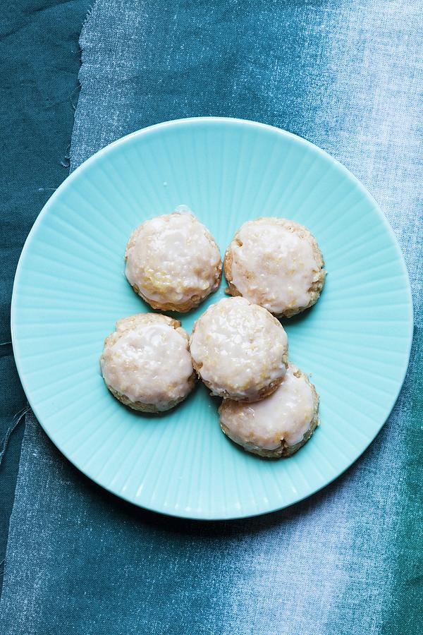 Iced Lemon Cookies On A Blue Plate Photograph by Jennifer Martine