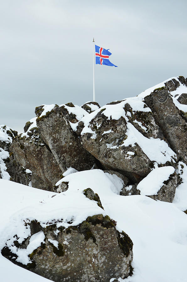 Icelandic Flag Waving AboveThingvellir National Park Boulders Photograph by Shawn OBrien