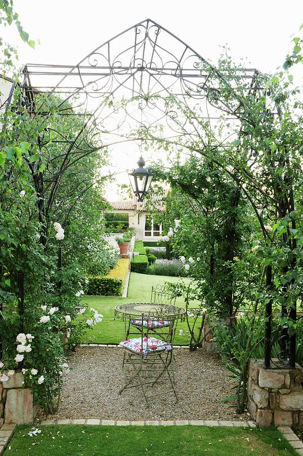 Idyllic Gazebo With Nostalgic Trellising And Roses Surrounding Central Seating Area Photograph by Great Stock!