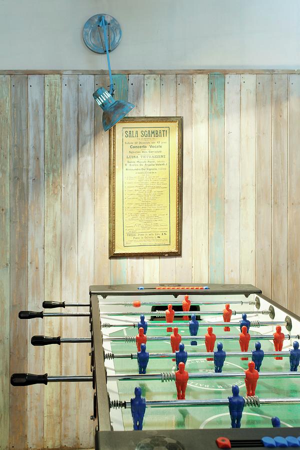 Illuminated Games Area With Football Table And Simple Wood-panelled Wall Photograph by Luxup