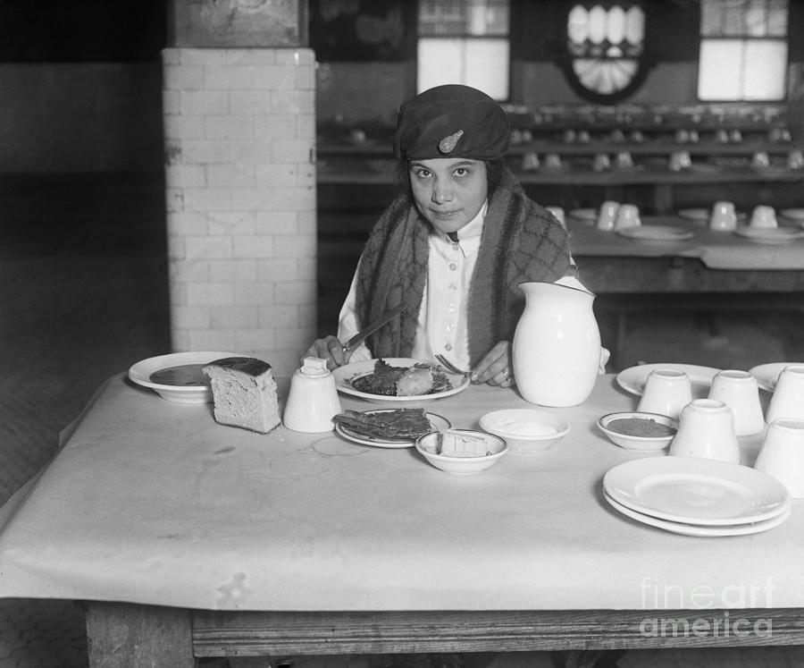 Immigrant Eating Meal On Ellis Island Photograph by Bettmann