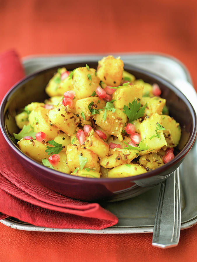 Indian Bombay Potatoes With Pomegranate Seeds Cumin Seeds And Coriander Photograph by Michael Paul