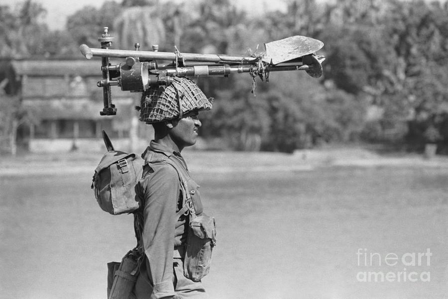 Indian Soldier Walks, Gear On Head Photograph by Bettmann