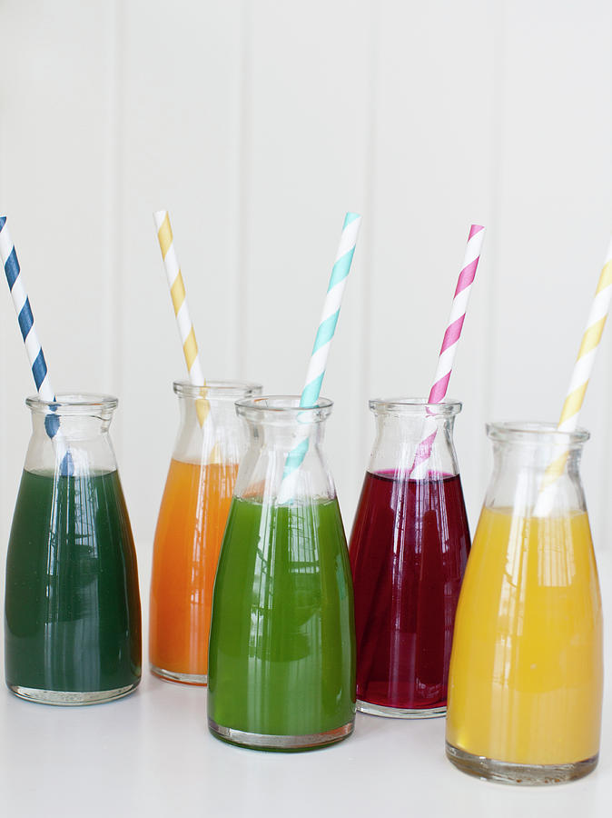 Individual Jars Of Fresh Pressed Juices With Straws spirulina, Orange Carrot Turmeric, Spinach, Beet And Lemon Ginger Photograph by Ryla Campbell
