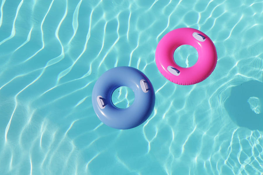 Inflatable Rings In Pool Photograph by Peter Cade Inflatable Rings In Pool Photograph by Peter Cade