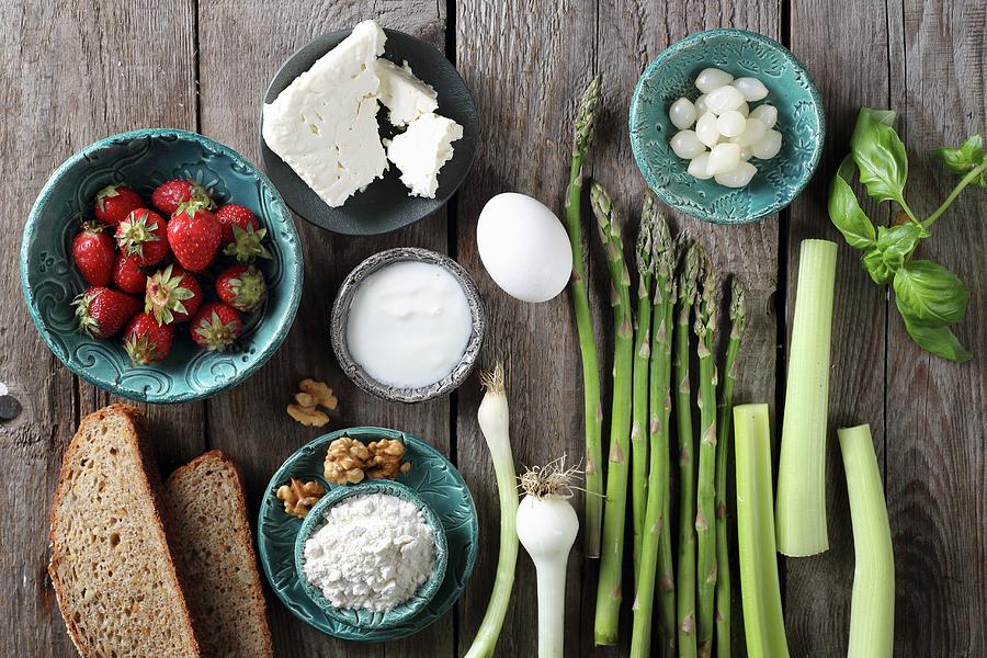 Ingredients For A Strawberry Salad With Asparagus, Bread, Spring Onions And Feta Photograph by Zita Csig
