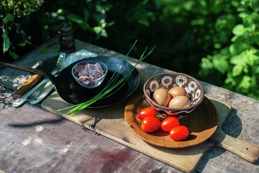 Ingredients For Making Scrambled Eggs On A Garden Table Photograph by Sebastian Schollmeyer