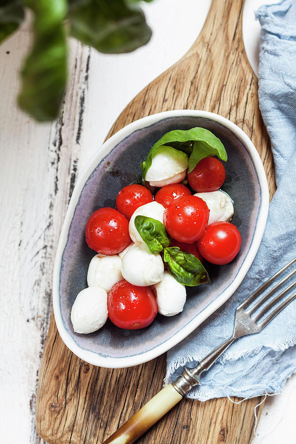 Insalata Caprese mozzarella With Cherry Tomatoes And Basil Photograph by Susan Brooks-dammann